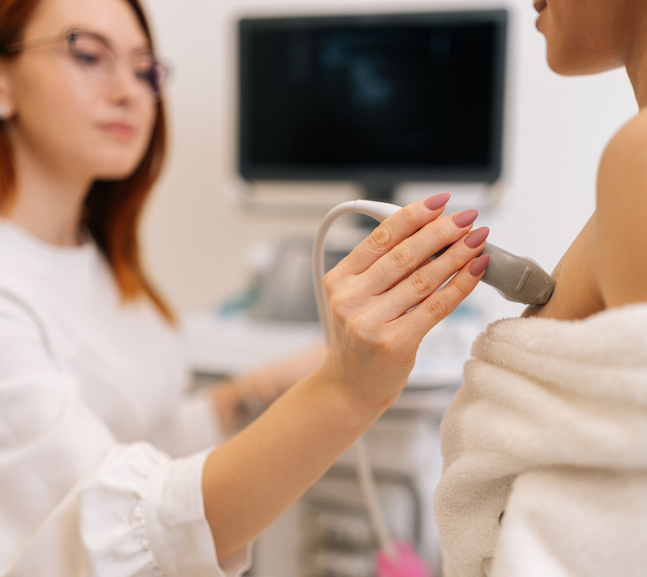 Médecin réalisant une échographie sur une patiente | dépistage cancer du sein | Imagerie Cardinet | Région Parisienne